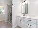 Contemporary bathroom featuring a glass-enclosed shower, white vanity, and tile flooring at 2505 Elon St, Charlotte, NC 28208