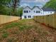 Spacious backyard with new wooden fence, offering privacy and room for outdoor activities at 2507 Elon St, Charlotte, NC 28208