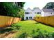Large, grassy backyard enclosed by a wooden fence, perfect for outdoor activities at 2507 Elon St, Charlotte, NC 28208