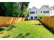Expansive backyard with lush green grass, privacy fence, and abundant sunshine at 2507 Elon St, Charlotte, NC 28208