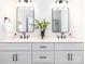 Elegant bathroom featuring dual sinks, modern lighting, sleek hardware, and lots of cabinet storage at 2507 Elon St, Charlotte, NC 28208