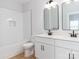 Modern bathroom with tub, toilet and double sink vanity at 2507 Elon St, Charlotte, NC 28208