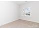 Bright bedroom with one window, carpet, and neutral walls at 2507 Elon St, Charlotte, NC 28208