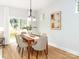 Elegant dining area with modern lighting, table setting, and backyard view at 2507 Elon St, Charlotte, NC 28208
