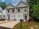 Charming new construction townhomes with neutral siding, white trim, and attached garages in a desirable neighborhood at 2507 Elon St, Charlotte, NC 28208