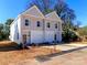 Charming townhomes featuring attached garages and modern design elements on a sunny day at 2507 Elon St, Charlotte, NC 28208