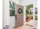 Open front door view showing bright interior, welcome mat, and exterior landscaping at 2507 Elon St, Charlotte, NC 28208