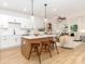 Open-concept kitchen featuring a center island, quartz countertops, stainless steel appliances, and pendant lighting at 2507 Elon St, Charlotte, NC 28208