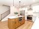 Gourmet kitchen featuring a center island with a built-in microwave, stainless steel appliances, and hardwood floors at 2507 Elon St, Charlotte, NC 28208