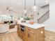 Open-concept kitchen showcasing an island with seating, stainless appliances, and hardwood floors at 2507 Elon St, Charlotte, NC 28208