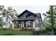 An inviting angle showcasing a two-story home, featuring stone accents, a porch, and a well-maintained yard at 2557A Hemphill St, Charlotte, NC 28208