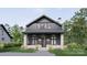 An elevation of a two-story home showcasing its architectural details, stone accents, and porch at 2557A Hemphill St, Charlotte, NC 28208