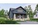 A front view showcasing a two-story home with a stone porch and complementary landscaping at 2557A Hemphill St, Charlotte, NC 28208