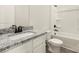 Bathroom featuring granite countertops, modern fixtures, and a bathtub with white tiling at 3338 Strong Box Ln, Gastonia, NC 28052