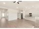 Spacious open-concept living area with light wood floors, vaulted ceilings, and a modern kitchen at 3338 Strong Box Ln, Gastonia, NC 28052