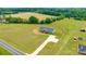 Aerial view of a well-maintained home with a long driveway, surrounded by lush greenery and additional outbuildings at 3648 Plainfield Dr, Shelby, NC 28150