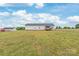 Home's backyard, showcases a well-maintained lawn, partially fenced, and beautiful landscaping at 3648 Plainfield Dr, Shelby, NC 28150