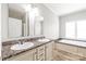 Bright bathroom featuring double sinks, a soaking tub, and ample natural light from a large window at 3648 Plainfield Dr, Shelby, NC 28150