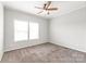 Cozy bedroom featuring a ceiling fan, neutral carpet, and a bright window for natural light at 3648 Plainfield Dr, Shelby, NC 28150
