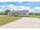 Well-manicured lawn and extended drive complement the pleasant gray home at 3648 Plainfield Dr, Shelby, NC 28150