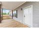 Covered front porch with wooden deck and white front door at 3648 Plainfield Dr, Shelby, NC 28150