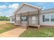 Close up of a well maintained gray home's inviting covered front porch at 3648 Plainfield Dr, Shelby, NC 28150