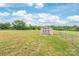 Backyard shed, featuring a fenced yard, green grass, and serene blue skies at 3648 Plainfield Dr, Shelby, NC 28150