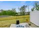 Backyard patio with plants overlooking a grassy lawn and views of the neighborhood at 3813 Amalia Pl, Indian Land, SC 29707