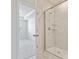 Bathroom with a glass-enclosed shower and marble tile at 3813 Amalia Pl, Indian Land, SC 29707