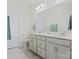 Well-lit bathroom featuring double sinks, a large mirror, and modern fixtures at 3813 Amalia Pl, Indian Land, SC 29707