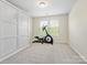 Bright bedroom with a large window, built-in wardrobe, and exercise bike at 3813 Amalia Pl, Indian Land, SC 29707