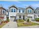 Beautiful townhouse with a landscaped front yard, attached garage, and charming exterior details at 3813 Amalia Pl, Indian Land, SC 29707