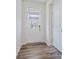 Bright foyer featuring wood-look flooring and a stylish front door with a window at 3813 Amalia Pl, Indian Land, SC 29707