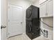 Well-lit laundry room with stacked washer and dryer and ample storage cabinets at 3813 Amalia Pl, Indian Land, SC 29707