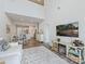 Open-concept living room with high ceilings seamlessly connects to a modern kitchen and dining area at 3813 Amalia Pl, Indian Land, SC 29707