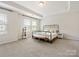 A bright main bedroom with ample natural light, tray ceiling, and neutral decor at 3813 Amalia Pl, Indian Land, SC 29707