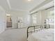 Bright main bedroom featuring a large window and en-suite bathroom entrance at 3813 Amalia Pl, Indian Land, SC 29707