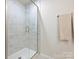 Modern shower with marble-style tile, glass door, and a neutral-colored towel rack at 3813 Amalia Pl, Indian Land, SC 29707