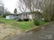 Rear view of home with stairs leading to red door and large lawn at 412 E Broad St, Salisbury, NC 28144