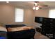 Bedroom with a ceiling fan, two windows, and a dark-colored dresser, with wood flooring at 412 E Broad St, Salisbury, NC 28144