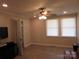 Bedroom with wood-look floors, modern ceiling fan, and two windows with white blinds at 412 E Broad St, Salisbury, NC 28144