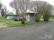 Charming single-story home with a gray brick exterior and inviting front porch at 412 E Broad St, Salisbury, NC 28144