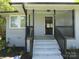 Inviting front porch with white brick stairs leading to a gray painted brick home with black accents at 412 E Broad St, Salisbury, NC 28144
