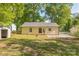 View of the rear of the house featuring a backyard with mature trees and a fenced-in area at 4336 Valeview Ln, Charlotte, NC 28269
