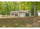 Charming single-story home with a white brick facade, black shutters, and a well-manicured lawn surrounded by mature trees at 4336 Valeview Ln, Charlotte, NC 28269