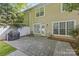 Backyard with a stone patio, grill, and furniture, perfect for outdoor entertaining at 4418 Coventry Row Ct, Charlotte, NC 28270