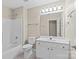 Well-lit bathroom features a shower-tub combo and a vanity with a large mirror at 4418 Coventry Row Ct, Charlotte, NC 28270