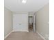 Neutral bedroom with double closets, light-colored carpet, and a view to the hallway at 4418 Coventry Row Ct, Charlotte, NC 28270