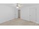 Bright bedroom featuring neutral carpet, ceiling fan, and window for natural light at 4418 Coventry Row Ct, Charlotte, NC 28270