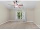 Bedroom with neutral carpet, ceiling fan, and a window offering natural light at 4418 Coventry Row Ct, Charlotte, NC 28270